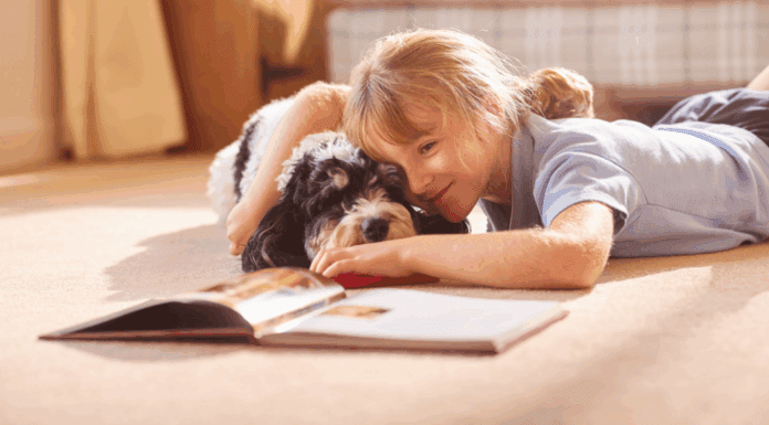 National Book Lovers Day A girl reading a book to her dog.