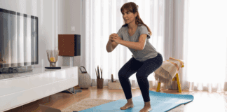Budget-Friendly Home Workouts: Get Fit Without Breaking the Bank A woman working out on a yoga mat at home.