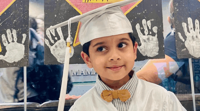 A little boy in his preschool graduation cap and gown.