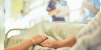 Life is Precious People holding hands in a hospital bed.