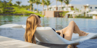A woman lounging on a raft in a pool finally having a real vacation.