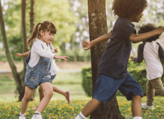 Overcoming Social Challenges Kids chasing each other outside around a tree.