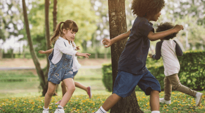 Overcoming Social Challenges Kids chasing each other outside around a tree.
