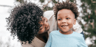 The Never Ending Transitions of Motherhood A mom looking down on her son.