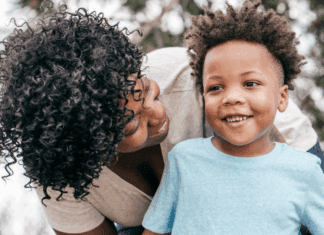 The Never Ending Transitions of Motherhood A mom looking down on her son.
