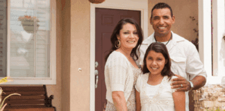 A Hispanic family in front of their house.