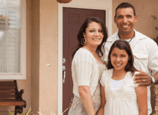 A Hispanic family in front of their house.