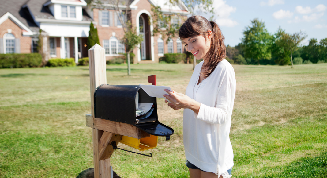 A woman checking the mailbox.