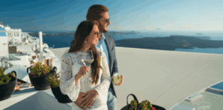 How to Avoid the Trap of Debt: Keeping up With the Joneses A rich couple drinking and holding one another.