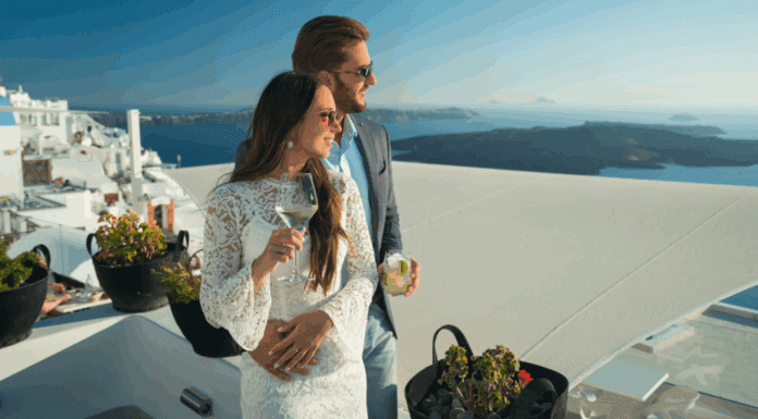 How to Avoid the Trap of Debt: Keeping up With the Joneses A rich couple drinking and holding one another.