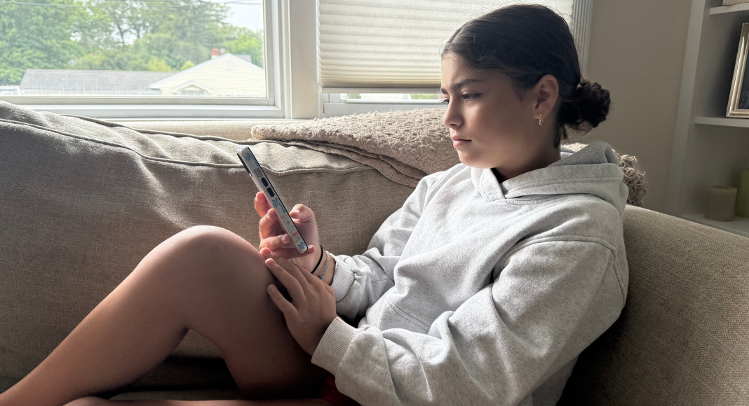 A teen girl on her cell phone.
