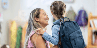 Separation Anxiety: Tips for Parents to Ensure a Smooth Drop-Off A mom saying goodbye to her daughter at school drop-off.