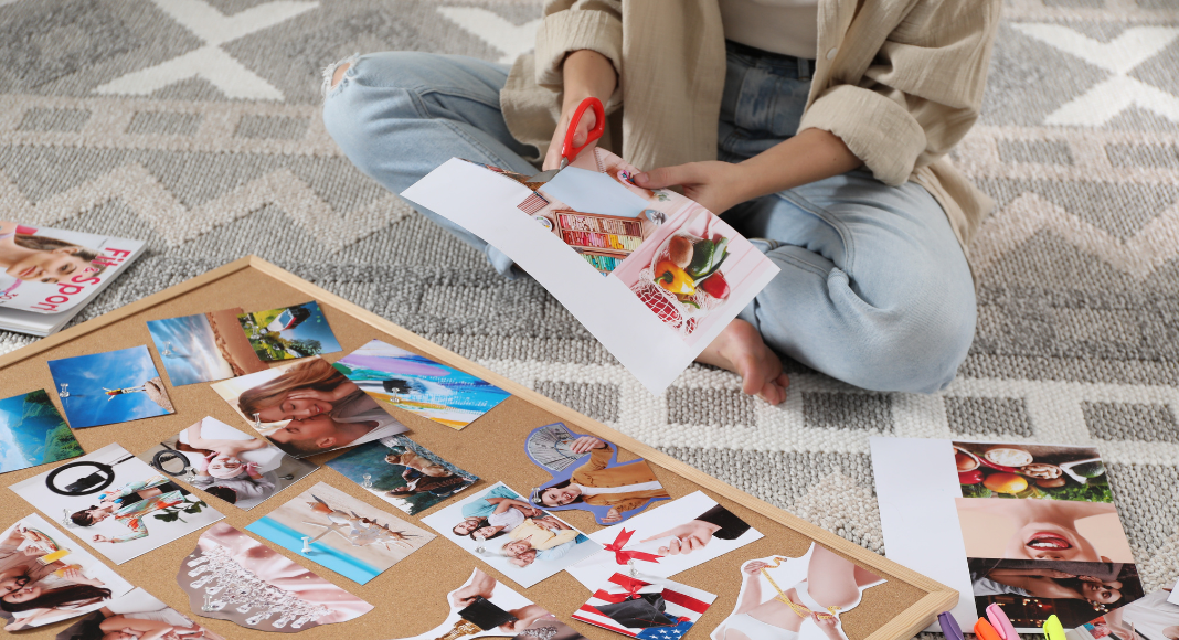 A woman cutting photos for a vision board. 