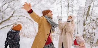 Family playing in the snow in on a winter getaway