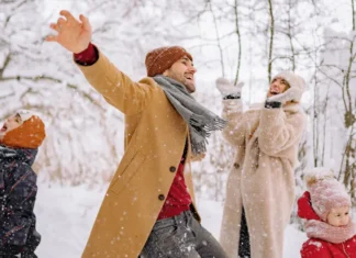 Family playing in the snow in on a winter getaway