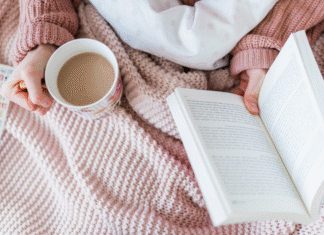 Holding a book and coffee.