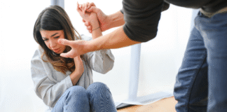 A man grabbing a woman's wrist.