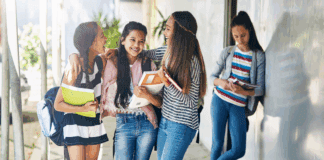 A clique of girls with one girl left out.