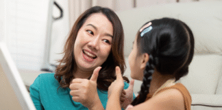 I Get to Say Yes A woman giving a thumbs up to her daughter.