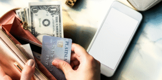 How to Avoid the Trap of Debt: Lifestyle Inflation An open wallet with cash and credit cards.