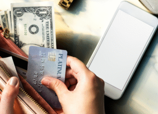 How to Avoid the Trap of Debt: Lifestyle Inflation An open wallet with cash and credit cards.