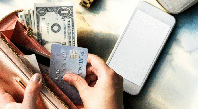 How to Avoid the Trap of Debt: Lifestyle Inflation An open wallet with cash and credit cards.