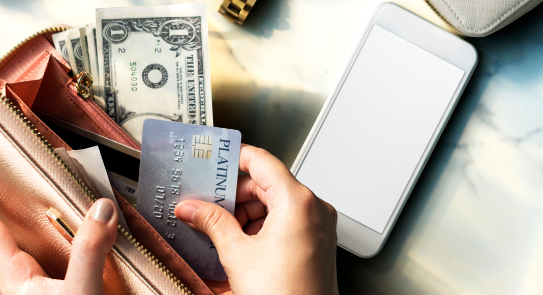 An open wallet with cash and credit cards.