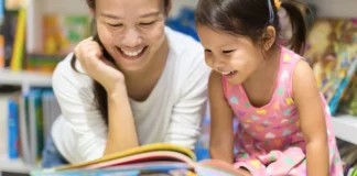 The Sweetest Little Bookstores in Westchester for Kids Mother and daughter reading a book at a bookstore in Westchester.