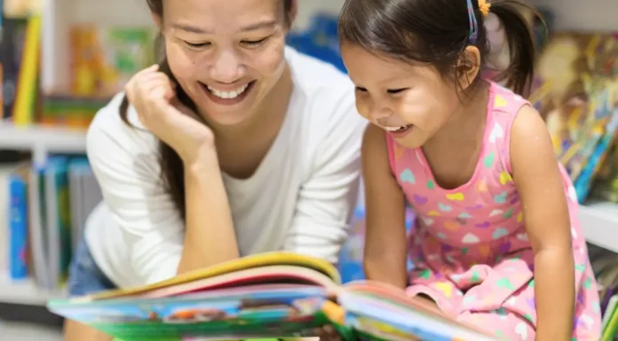 The Sweetest Little Bookstores in Westchester for Kids Mother and daughter reading a book at a bookstore in Westchester.