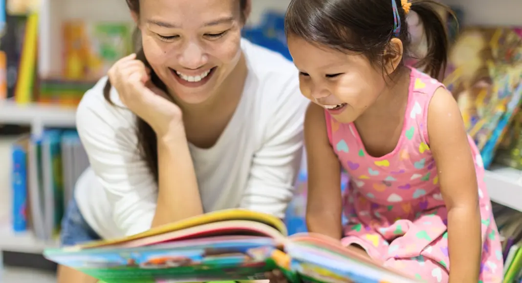 Mother and daughter reading a book at a bookstore in Westchester.