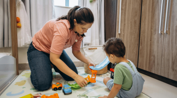 A mom playing on the floor with her son.