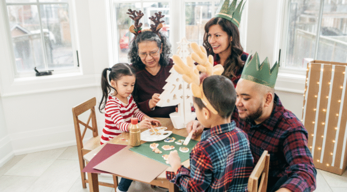 A family wearing hats and making a craft.