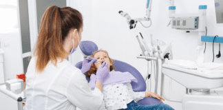 Building Healthy Smiles in Westchester County: Why “Timely” Orthodontic Care Matters Summerfield Orthodontics doctor examining a patient.
