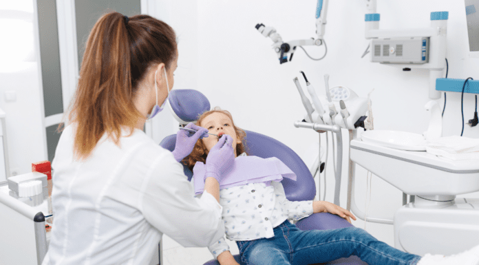 Building Healthy Smiles in Westchester County: Why “Timely” Orthodontic Care Matters Summerfield Orthodontics doctor examining a patient.