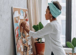 A woman creating her dreams on a vision board.