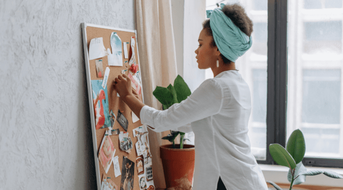 Make Your Dreams Come True A woman creating her dreams on a vision board.