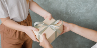 A Surprising Hidden Cost to Parenting Neurodivergent Kids Giving a teacher a gift.