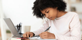 Getting a Head Start on the College Essay A girl writing a college essay.