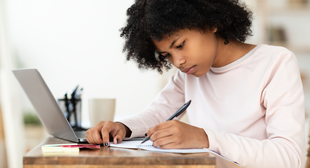 A girl writing a college essay.