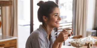 Making Space When Life Feels Loud A woman pausing and enjoying a cup of coffee.