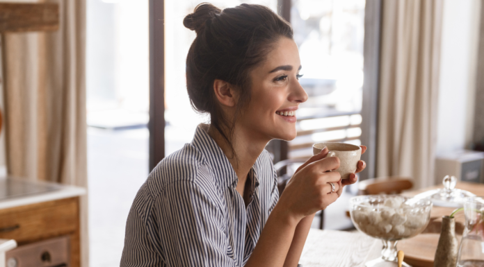 Making Space When Life Feels Loud A woman pausing and enjoying a cup of coffee.
