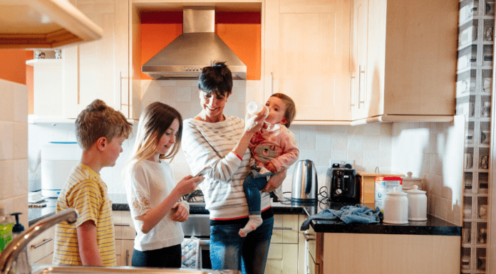 When All the Stages Collide A mom with three kids of different ages in the kitchen.