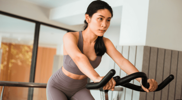 A woman on a stationary bike.