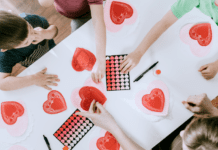 Sweet and Simple Sensory-Friendly Valentine’s Day Fun for Toddlers and Preschoolers Kids working on a Valentine's Day sensory activity.