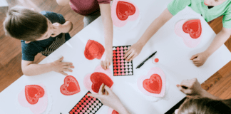 Kids working on a Valentine's Day sensory activity.