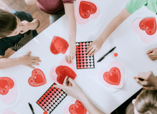 Kids working on a Valentine's Day sensory activity.