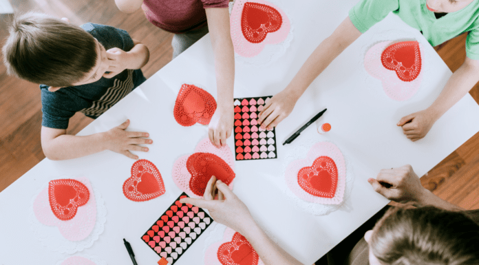 Kids working on a Valentine's Day sensory activity.