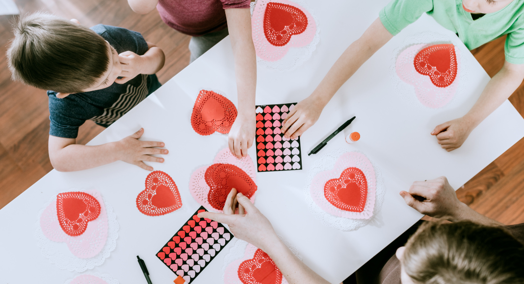 Kids working on a Valentine's Day sensory activity.