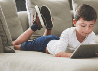 Online Safety: Protecting Our Children A boy laying on the couch online.