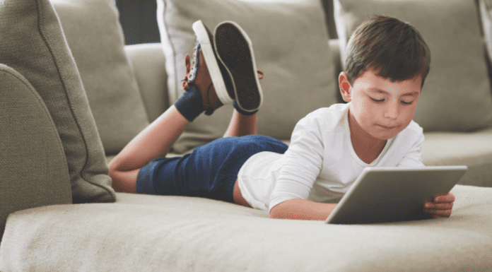Online Safety: Protecting Our Children A boy laying on the couch online.